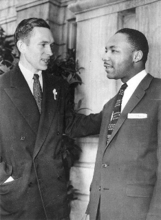 A black and white photo as Reverend Goetz standing next to Dr. Martin Luther King, Jr